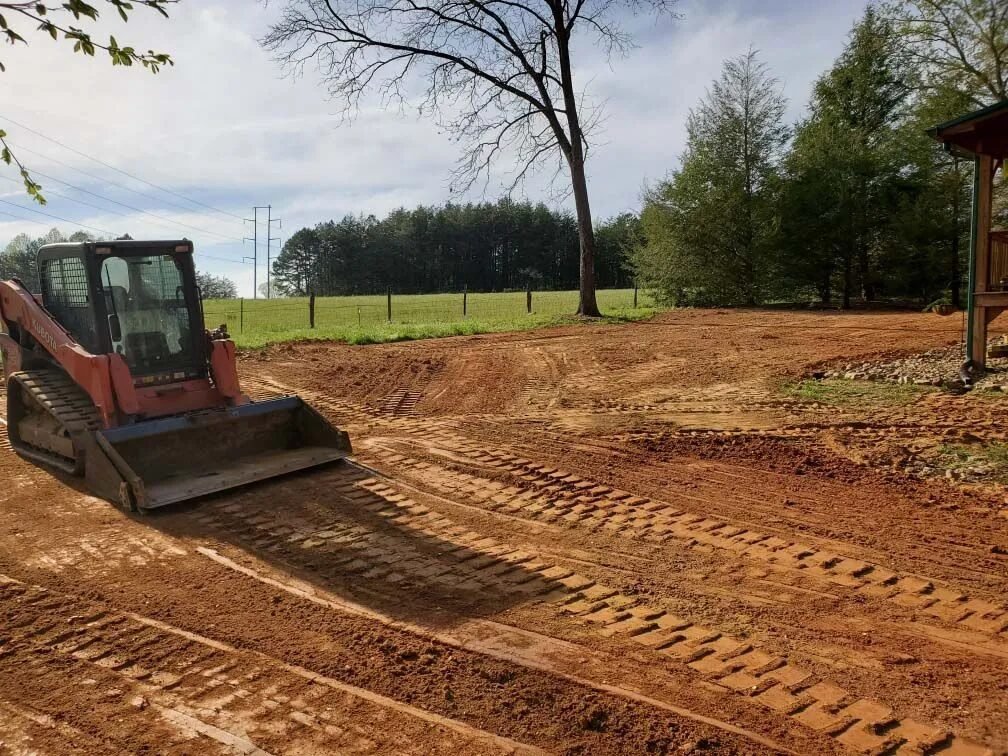 Skid steer clearing land in Fresno